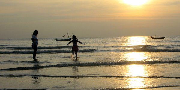 beach sunset kid playing in shallows
